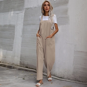 Loose fit khaki cotton linen overalls with wide legs and big front pockets over a white tee