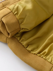 Close-up of the ginger yellow suede jacket showing smooth silk lining and fine stitching
