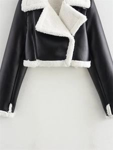 Detail of cropped women's biker jacket with faux leather and white shearling trim edges