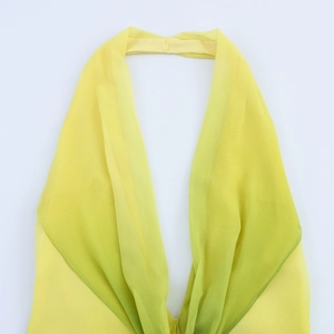 Detailed view of yellow gradient halter neck dress with delicate sewing and light fabric