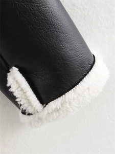 Detailed close-up of winter jacket cuff featuring black faux leather and white sherpa lining
