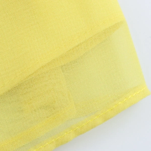Detailed close-up of yellow floral chiffon fabric showing fine mesh weave and neat stitching