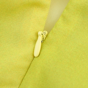 Detail of hidden zipper and woven fabric texture on the floral lime green maxi dress