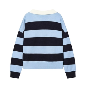 Close-up of contrast white polo collar and navy blue striped knitted texture on sweater