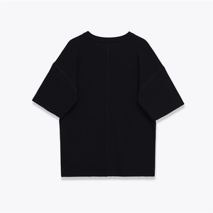 Back view of minimalist black crewneck short sleeve knit top with vertical seam detail