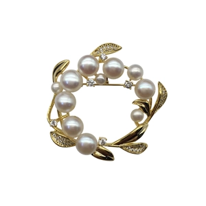 Elegant gold flower wreath brooch featuring natural freshwater pearls and sparkling zircon