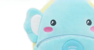 Macro view of blue elephant plush bag featuring soft fabric and detailed embroidery
