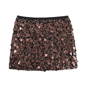 Detail of shimmering coffee sequins and black elastic waistband on the mini party skirt