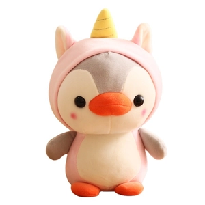 Cute penguin plush toy in pink unicorn costume with yellow horn on white background