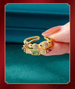 Close-up of gold open ring with colorful zircon stones on green velvet background