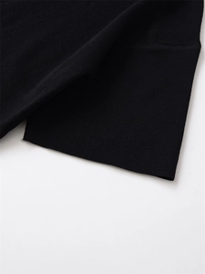 Close-up of the fine knit texture and elastic ribbed cuff on this black short sleeve sweater