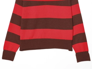 Detail of red and brown striped knit sweater showing ribbed cuffs and hemline texture