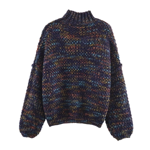 Macro detail of mixed-color thick knit sweater with mock neck and textured fibers