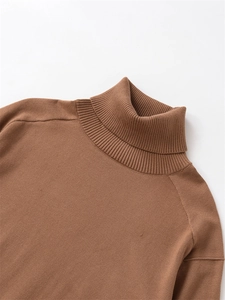 Close-up of brown wool turtleneck sweater showing ribbed collar and knit texture