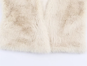 Close-up of beige faux fur vest showing soft texture and premium plush material