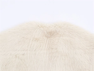 Detailed close-up of light beige faux fur texture on the collar of a stylish vest