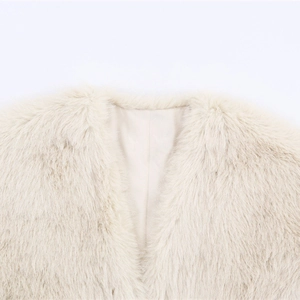 Chic beige faux fur vest showing plush neckline detail and smooth silk lining