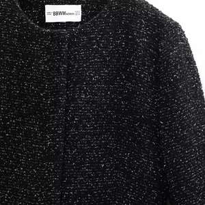 Detailed view of women's black tweed jacket with woven texture and BBWM brand neck label