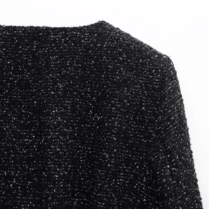 Macro shot of the black and white textured tweed fabric for the chic blazer jacket