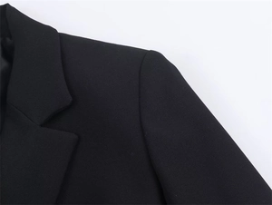 Detail shot of the structured shoulder with pads and lapel of the black business blazer