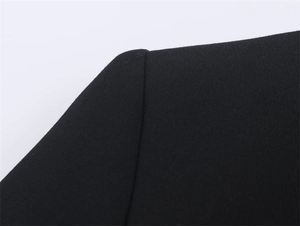 Detailed view of structured shoulder seam and smooth stitching on a black blazer jacket