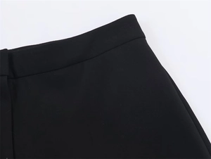 Detail shot showing the smooth waistline and premium twill fabric of black suit trousers