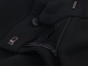 Detail of black suit trousers waist closure featuring metal zipper, button and hooks