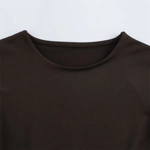 Close-up of the crew neck collar and fine knit texture of this coffee brown bodysuit