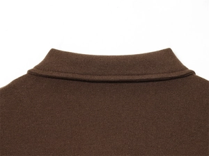 Detailed close-up of brown knit polo collar showing premium stitching and fabric texture