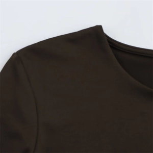 Close-up of the fine stitching and smooth fabric texture on the brown crew neck top