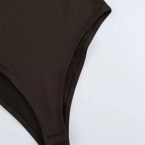 Close-up of reinforced stitching and high-elastic fabric on deep brown bodysuit legs