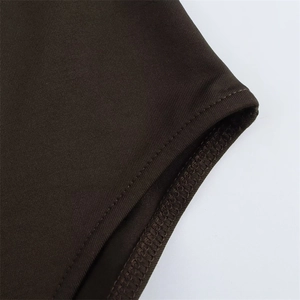 Detailed view of double-stitched seams on dark brown elastic knit bodysuit fabric