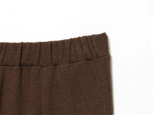 Detail of the high-elasticity ribbed waistband on these deep brown knitted wide-leg pants