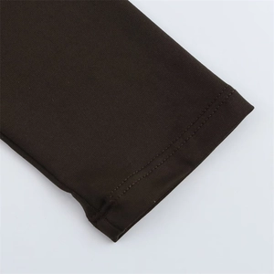 Detailed close-up of dark brown knit fabric with durable double-needle flat stitching