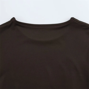 Detailed close-up of the round neckline and stitching on a dark brown long sleeve bodysuit