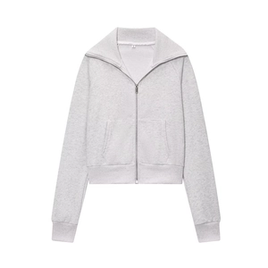 Detail of light grey fleece jacket showing lapel collar, metal zipper, and ribbed cuffs