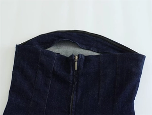 Detail of slim-fit denim tube dress featuring a durable metal zipper and premium stitching