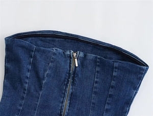 Detail of blue denim tube top showing metal zipper and vertical slimming seams