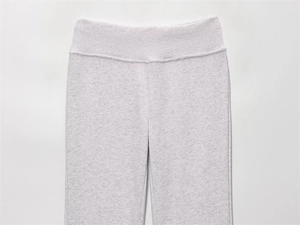 Detailed close-up of high-waist ribbed waistband on light grey marl joggers