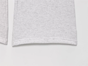 Close-up of heather grey knit joggers featuring high-quality double-needle stitched hem