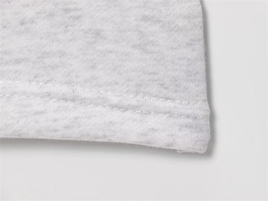 Close-up of double-needle stitching on grey marle fleece jacket and flared pants hem