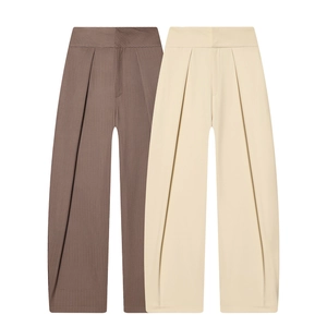 Detail view of high-waist pleated balloon pants in brown stripe and cream white colors