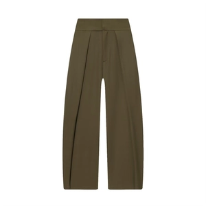 Detail of high-waist olive green trousers with front pleats and a wide-leg silhouette