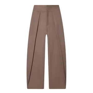 Detail view of high-waist pleated balloon trousers with vertical brown pinstripe texture