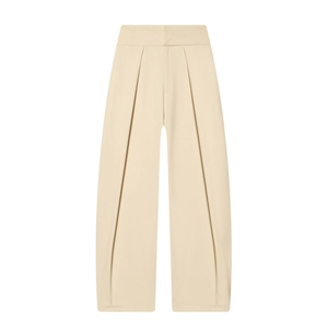 Detail of high-waist cream pleated balloon trousers with elegant drape texture