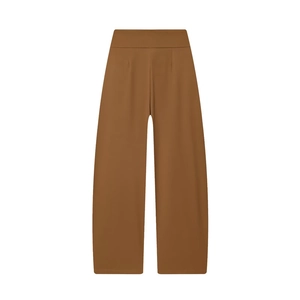 Detailed view of high-waist brown balloon pants with smooth drape and elegant pleated texture