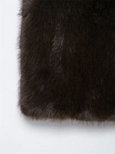Detailed macro view of high-quality dark brown faux fur texture on a fashion vest