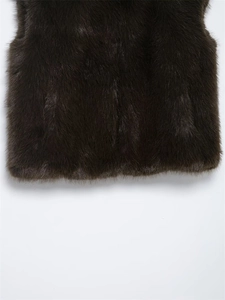 Detailed macro view of smooth dark brown faux fur texture and seamless vest hemline