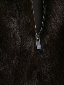 Detail shot of the high-quality silver metal zipper on a dark faux fur fashion vest