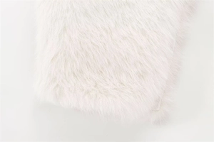 Close-up detail of luxurious soft white faux fur texture with long dense fibers